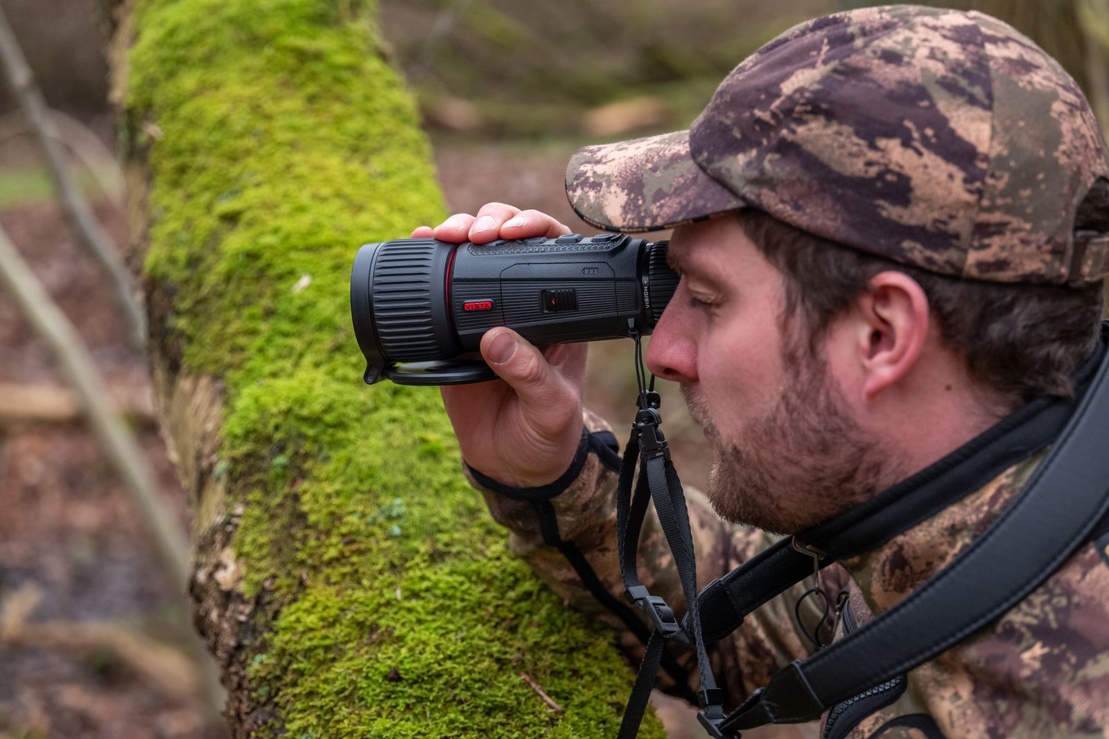 Hunter uses the Nocpix Vista Series thermal imaging monoculars in a forest.