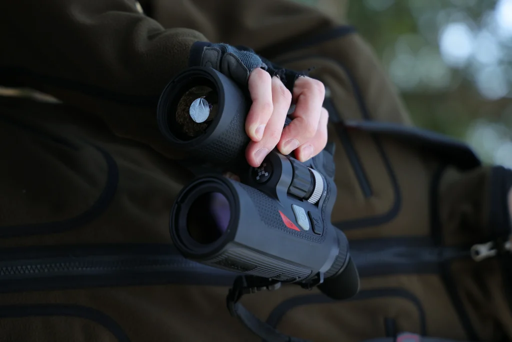 Close-up of the lens of a thermal binocular showing optical components